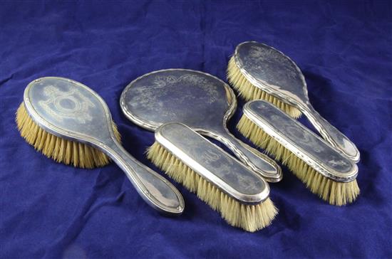 A matched George V five piece silver dressing table set